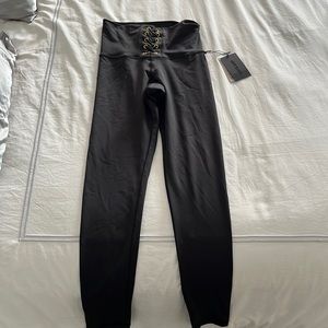Strut this leggings with gold laces in front